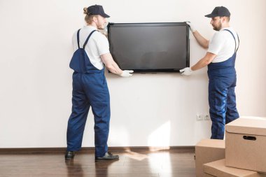 Teslimat manremove Tv duvarından bir daire için hareket etmek için. ulaşım, Tulum içinde erkek yükleyici profesyonel çalışan