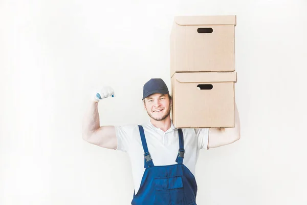 Consegna forte, uomo muscoloso caricare scatole di cartone per il trasferimento in un appartamento. lavoratore professionista dei trasporti, caricatori maschili in tuta. spazio libero per testo, isolato — Foto Stock