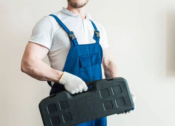 male in overalls plumber, electrician, with tools, home repair, husband for an hour
