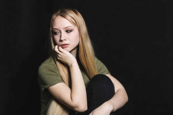 Mujer joven triste va a llorar en un fondo negro — Foto de Stock