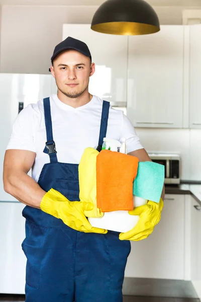 Cleaning service with professional equipment during work. professional kitchenette cleaning, sofa dry cleaning, window and floor washing. man and women in uniform, overalls and rubber gloves — Stock Photo, Image