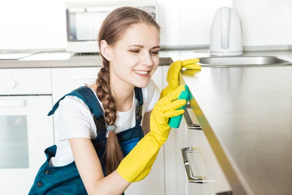 Cleaning service with professional equipment during work. professional kitchenette cleaning, sofa dry cleaning, window and floor washing. man and women in uniform, overalls and rubber gloves — Stock Photo, Image