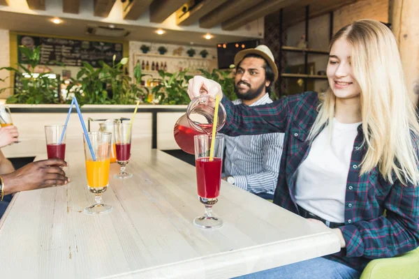 A company of young people having fun, drinking drinks, cocktails, juices in a cafe. Meeting best friends