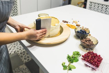Şekerleme spatulası ile bisküvi pastası üzerine beyaz krema. Ev yapımı hamur işi, kek pişirme....