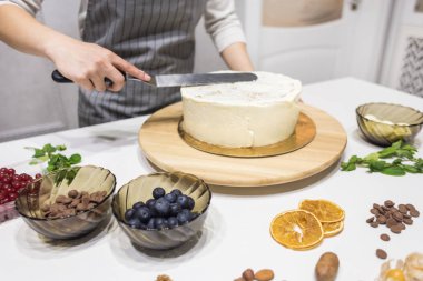 Şekerleme spatulası ile bisküvi pastası üzerine beyaz krema. Ev yapımı hamur işi, kek pişirme....