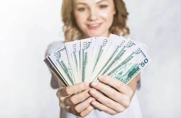 Happy young smiling woman hold us dollar money in hand over white background. — Stock Photo, Image