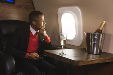 Başarılı genç Afro Amerikalı siyah işadamı onun özel jet koltuğunda oturan