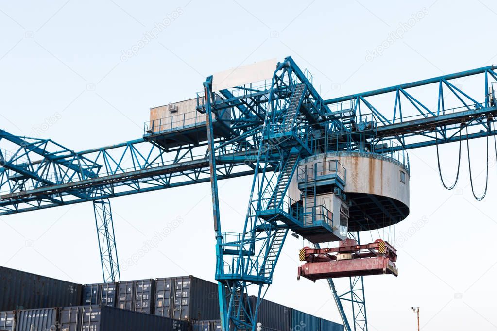 Large industrial port crane unloads cargo containers