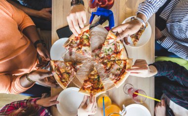 Bir kafede pizza yiyen, kokteyl içen, eğlenen çok kültürlü gençlerden oluşan bir şirket.