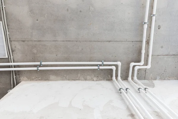 copper pipes in boiler-room on the wall close up