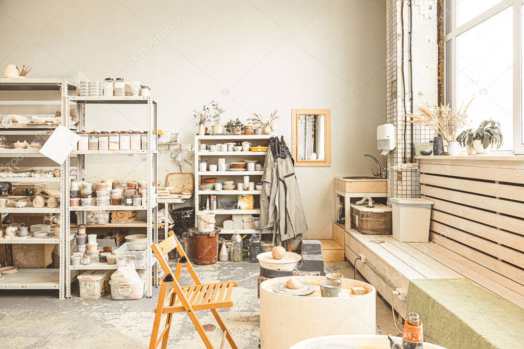 The interior of the creative workshop. shelves with finished products and materials and a pottery wheel for the manufacture of clay products