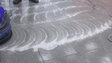 Temizlikçi rıhtımı profesyonel bir cilalama makinesiyle yıkıyor. Ofis binasının zeminini temizliyorum.