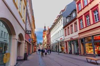 Heidelberg, Almanya - 8 Haziran 2025: Heidelberg 'de yayalar üzerinde renkli binalar, dükkanlar ve akşam manzarası sergileniyor.