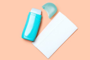 Açık deniz mavisi roll-on sıcak balmumu ısıtıcı ve kağıt şeritler turuncu zemin üzerine