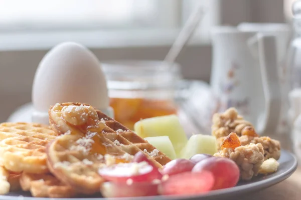 Easter breakfast. sunday lunch Easter concept. homemade waffles, eggs, fresh fruit and granola. toned image. selective focus
