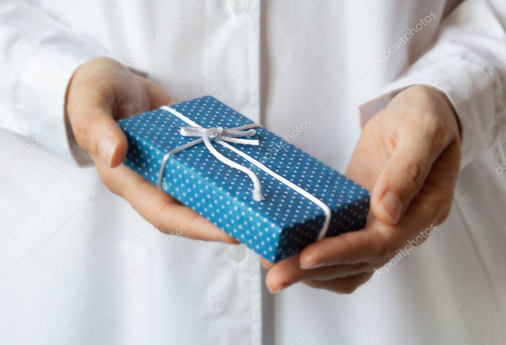 Gift box in womans hands. Christmas concept.