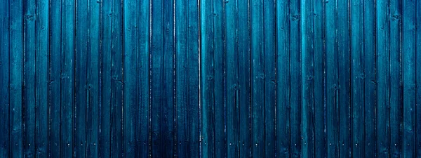 Dark blue wooden banner. Old plank fence.