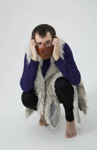 A man in a mask on his face. in vest, with fur — Stock Photo, Image