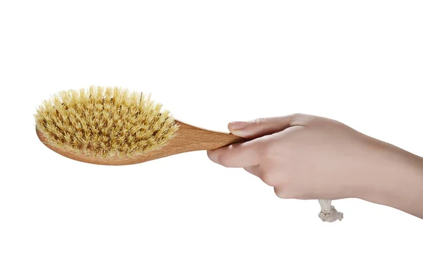 dry body massage brush, in hand, on a white background