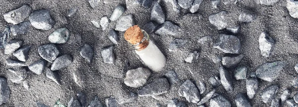 Stylish Sea Background Grey Sand Rocks Small Glass Bottle Sea — Stock Photo, Image