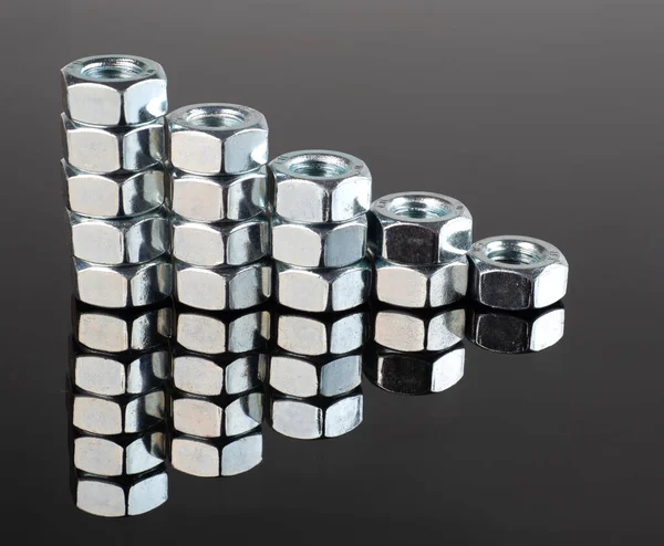 New Shiny Metal Nuts Mirrored Black Background — Stock Photo, Image
