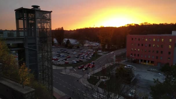 Время работы современного стеклянного лифта перед техническим центром Cesana на фоне заката, Млада Болеслав, Чехия — стоковое видео