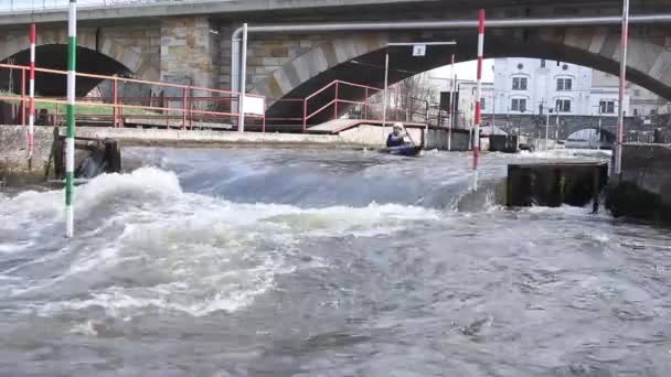 Kayak entrenamiento, Kayak Carrera cerca del puente donde el agua fuertes remolinos surgen cerca de las pilas — Vídeo de stock