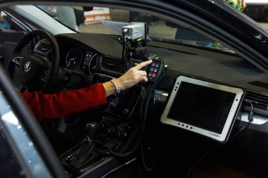 Prague, Czech Republic - April 13th 2019: Women Turn on Signal Light in Police Automobile Skoda Superb at Autoshow PVA EXPO Praha Letnany 2019. clipart