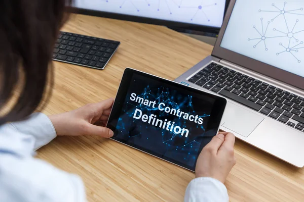Business Female Using Smart Contracts For Definition. Illustration of Ethereum Blockchain on the Screen of Tablet, PC and Laptop.