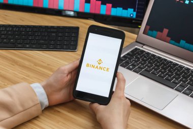 SAN FRANCISCO, US - 18 June 2019: Female Trader Hands Holding the Smartphone Using Application of Binance Cryptocurrency Exchange Market. Cryptocurrency Background Concept, San Francisco, California,  clipart