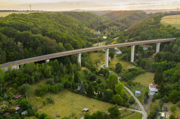 Aerial View of a Highway Bridge With Pillars in the Mountain or Hills With Trees