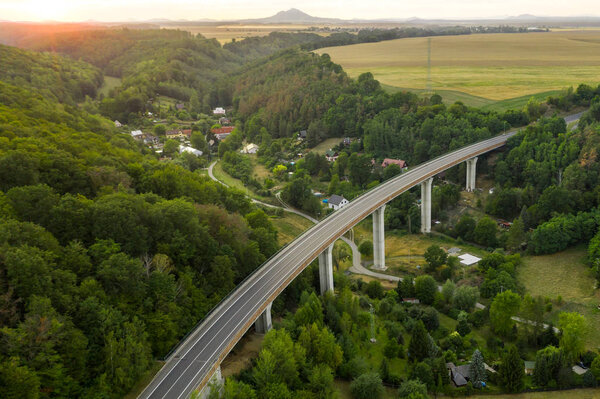 Aerial View of a Highway Bridge With Pillars in the Mountain or Hills With Trees