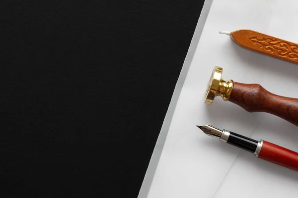Notary public wax stamper. White envelope with brown wax seal, golden stamp. Responsive design mockup, flat lay. Still life with postal accessories.