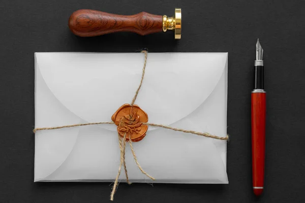 Notary public wax stamper. White envelope with brown wax seal, golden stamp. Responsive design mockup, flat lay. Still life with postal accessories. — Stock Photo, Image