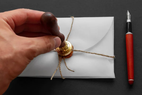 Notary public wax stamper. White envelope with brown wax seal, golden stamp. Responsive design mockup, flat lay. Still life with postal accessories. — Stock Photo, Image