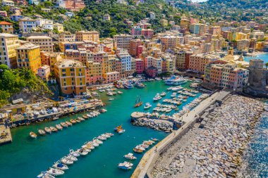 Aerial view of Camogli. Colorful buildings near the ligurian sea beach. View from above on boats and yachts moored in marina with green blue water. clipart