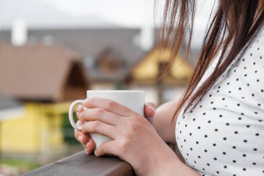 Kadınların elini kapayın, balkonda kahve ya da çay ile birlikte beyaz bir fincanla dağların ve villaların muhteşem manzaralı çatılarını tutun.