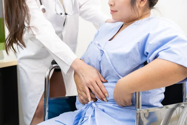 Doktor, şişman kadın hastaya aşırı kilo problemi hakkında danışmanlık yapıyor. Günlük yaşam konseptinde sağlık ve sağlıklı yaşam tarzı.