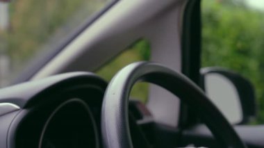 Sürücü hijyen ıslak doku kullanarak araba vitrini ve direksiyon simidini temizliyor.. 