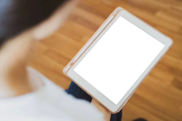 Asian woman reading the ebook on the tablet close up, empty white screen tablet isolated in white color with clipping path. Woman browsing the social media and chatting in the internet.