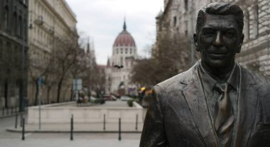 Arka planda Budapeşte Parlamentosu binası ile Ronald Reagan heykeli