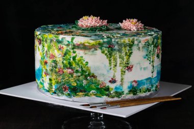Hand painting buttercream water lilies cake. Homemade baking. Decorating cream cake with food coloring. Designer Cake. Selective focus. Horizontal. clipart
