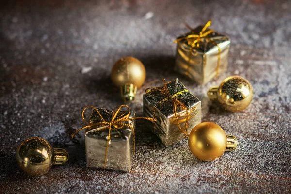 Christmas present mini golden box in the snow background. Close up. Christmas holiday celebration and new year concept. Winter holiday background.Christmas present mini golden box in the snow background. Close up. Christmas holiday celebration and ne