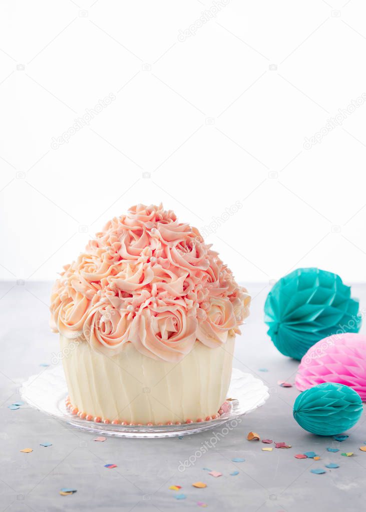 Delicious birthday cake cupcake and party balls, colorful confetti, on white background with space for text. Celebration party background concept.