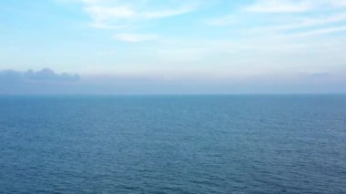 İnsansız hava aracı mavi denizin üzerinde gittikçe yükselir. Okyanus manzarası ve ufuktaki bulutlar. Güzel deniz manzarası 