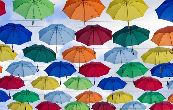 colorful umbrellas in sunny weather suspended in the air