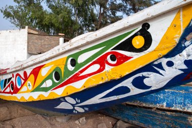 Mbour, Senegal: Detail of colourful fishing boats stranded in th clipart