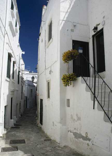 Ostuni, Puglia, Italy March 22nd 2019: Street view of an alley in the old town