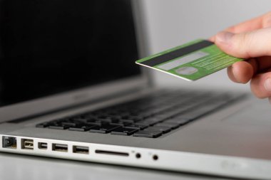Online bankacılık. Internet üzerinde para yönetimi. Finansal tablolar. Kredi ya da banka banka kartı siyah tuşları ile gümüş laptop.