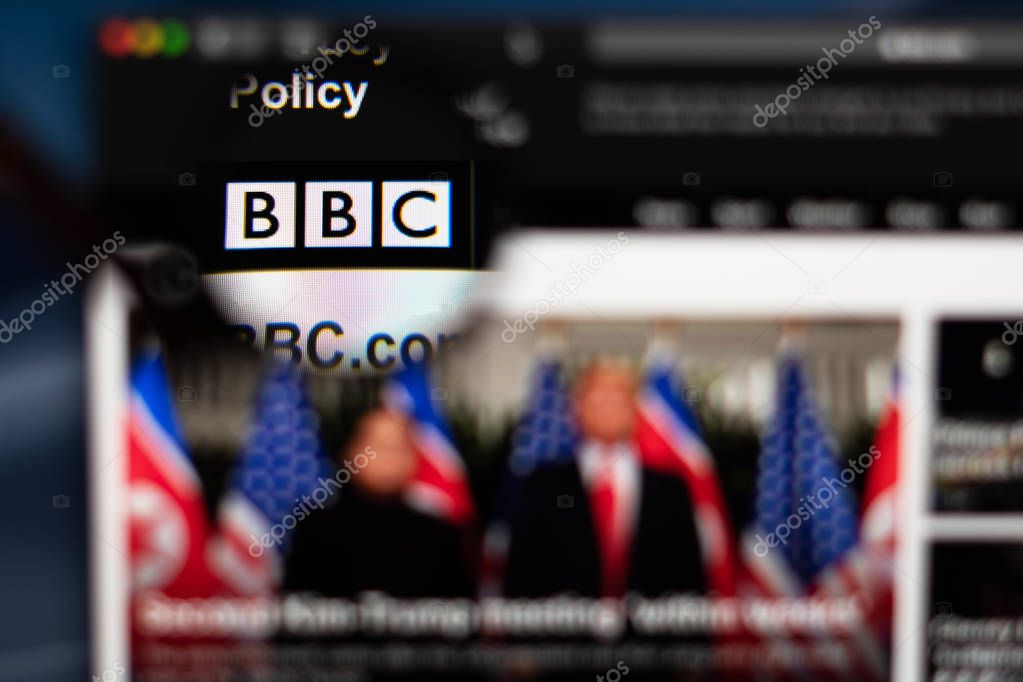 BBC News website homepage. BBC logo visible  through a magnifying glass.